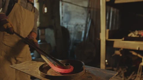 Blacksmith Heating Steel Workpiece in Forge and Bending It into Spiral Stock Footage 274388681