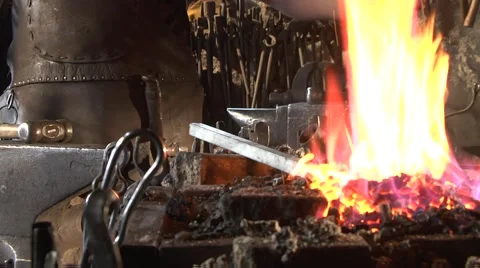 Blacksmith heats a stem in fire, he is preparing for forging. Stock Footage 49393421