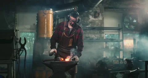 The blacksmith hits the metal with powerful blows Видео 165211418