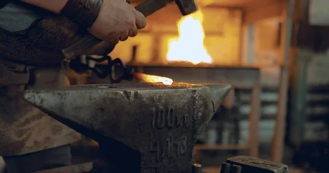 A blacksmith hitting an anvil. Close up Stock Footage 98659210