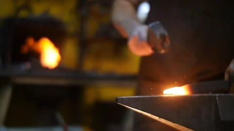Blacksmith Hitting Hot Metal on an Anvil with a Hammer Stock Footage 55449524
