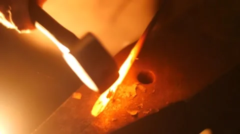Blacksmith Hitting Hot Metal with a Hammer on an Anvil in Slow Motion Stock Footage