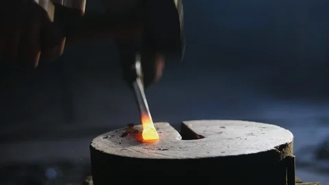 Blacksmith Hitting Hot Metal With a Massive Hammer Stock Footage 86415521