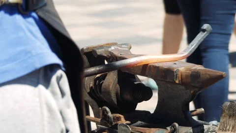 A Blacksmith Holding a Massive Hammer Banging Hot Metal Bar on Anvil. Smithy  Stock Footage 110836680