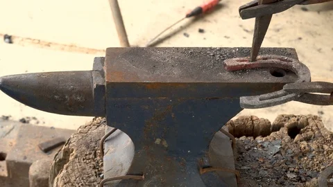 The blacksmith kicks a horseshoe close up Stock Footage 107174774