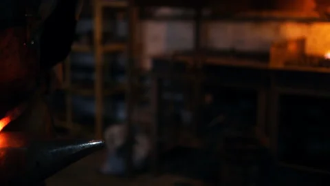 Blacksmith knocks with a hammer and sparks fly Stock Footage 100233787