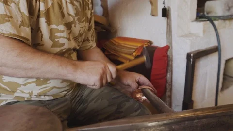 The blacksmith knocks with a hammer, giving a shape to the workpiece Stock Footage 94937544