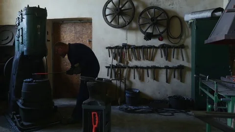 Blacksmith knocks out iron on a machine Stock Footage 78895928