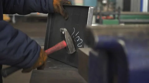 The blacksmith levels the billet with a large hammer 動画素材 150746799