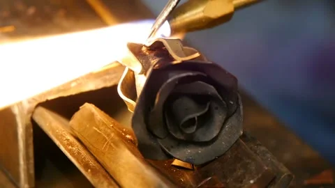 Blacksmith makes an iron rose. Man makes a rose out of iron. Stock Footage 101549799