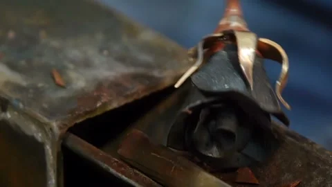Blacksmith makes an iron rose. Man makes a rose out of iron. Close up. Stock Footage 101549882
