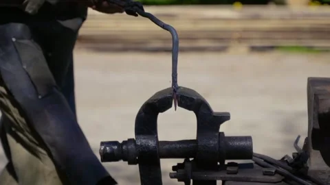 A blacksmith makes a metal detail Stock Footage 263837628