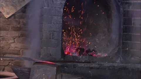 Blacksmith making broadswords Stock Footage 235267347