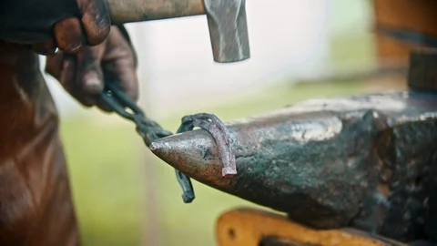 Blacksmith making a horseshoe - hitting the hot metal with a hammer Stock Footage 114125009