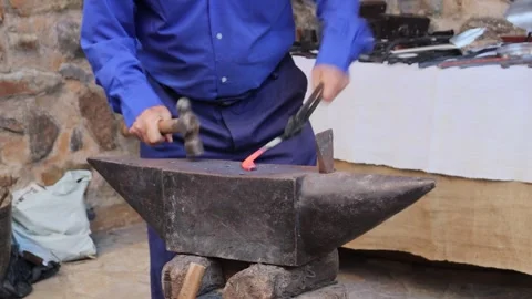 Blacksmith making a horseshoe with iron Stock Footage 245223320