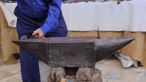 Blacksmith making a horseshoe with iron Stock Footage 245223325