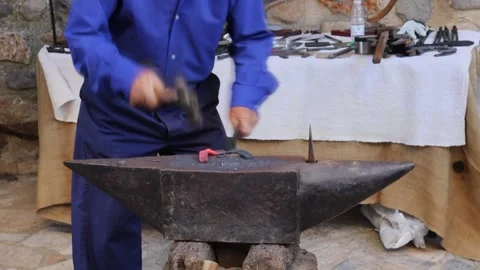 Blacksmith making an iron horseshoe in a traditional way Stock Footage 245223324