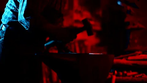 Blacksmith, A man blacksmith forging a hot knife blade using a hammer Stock Footage 150731551