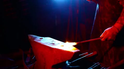 Blacksmith, A man blacksmith forging a hot knife blade using a hammer Stock Footage 150735513