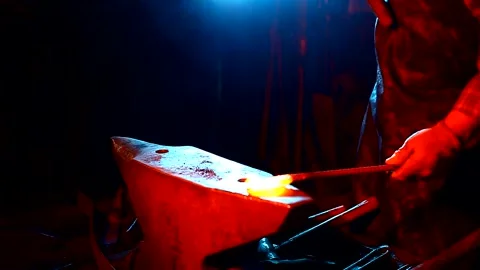 Blacksmith, A man blacksmith forging a hot knife blade using a hammer Stock Footage 150735948