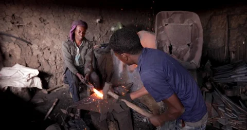 Blacksmith Man working with the bending metal Ethiopia Bahir Dar Stock Footage 119146039