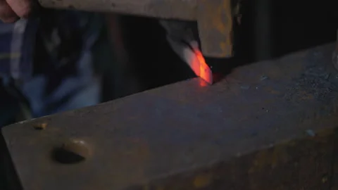 Blacksmith manually forging the molten fire. Stock Footage 146934310