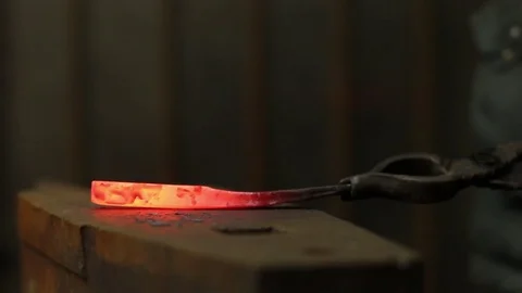 The blacksmith manually forging the molten metal on the anvil Stock Footage 72219888