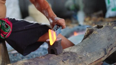 Blacksmith manually forging the molten metal on the anvil Stock Footage 107904608