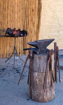 Blacksmith manually forging on the street, in the open. Stock Photos