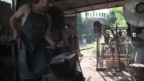 Blacksmith marking a decorative piece of metal. Stock Footage 247330326