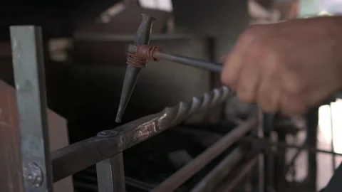 Blacksmith marking a rivet on a grating with a punch. Stock Footage 247330340