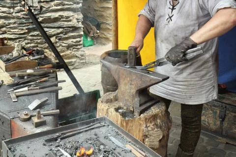 Blacksmith. Medieval tradition of making armor and swords at the forge. Stock Photos