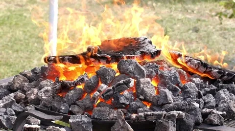 A blacksmith models a bar of iron with hammer after took it from fire forge. Stock Footage 66239297