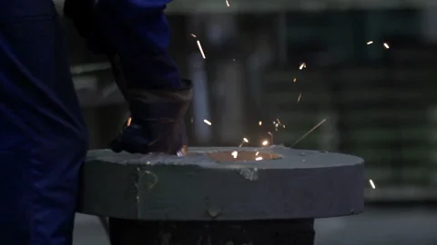 Blacksmith or welder,with its grinding smooths steel and iron,in extreme slow Stock Footage 130768445