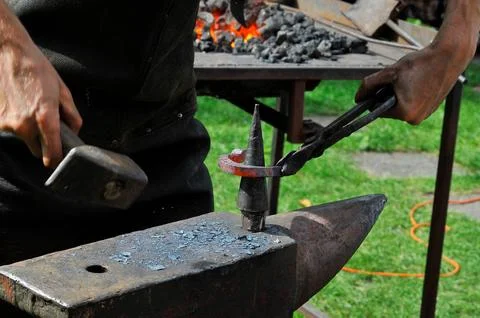 The blacksmith, a person who creates objects of iron or steel  Stock Photos