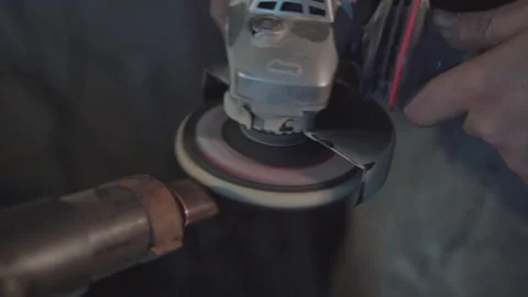 Blacksmith polishing knife handle with grinder. Damascus steel knife. Stock Footage 194524807