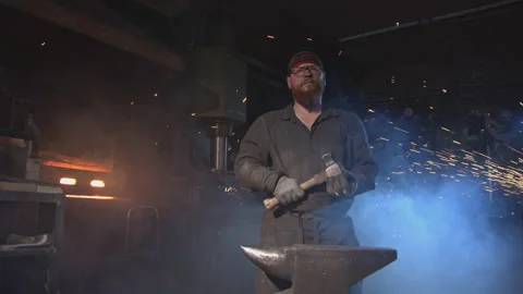 Blacksmith portrait in atmospheric workshop Видео 146461521