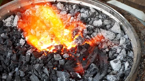 A blacksmith pounding a hammer on red-hot horseshoe on the anvil. Video stock 94267636