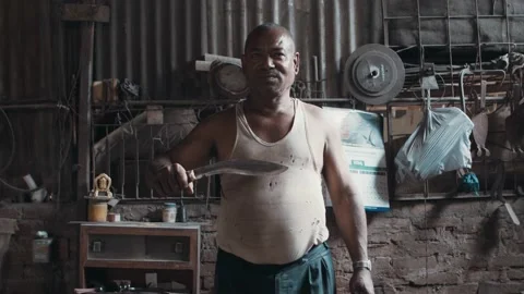 Blacksmith presenting finished new kukri knife Stock Footage 164192677