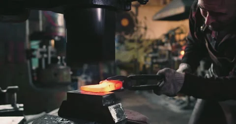A blacksmith is pressing a metal blank Video stock 165444316