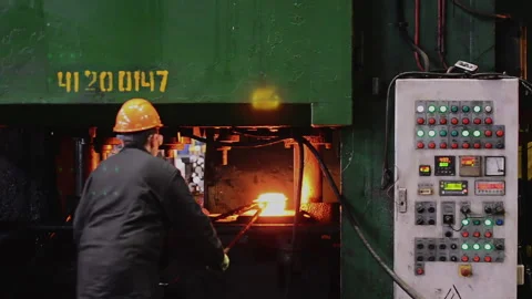 Blacksmith processes the red hot iron under a huge press. Stock Footage 224307705