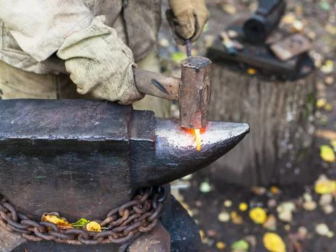 Blacksmith processing red hot iron rod on anvil Blacksmith processing red ... Stock Photos