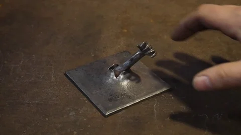 Blacksmith Products Being Displayed Such as a Tiny Steel Forged Hand Stock Footage 101246428