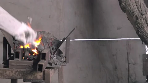 Blacksmith Pulling Out Hot Metal From The Furnace Stock Footage 139580904