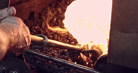 Blacksmith puts heats Axe in Forge 스톡 동영상 152396811