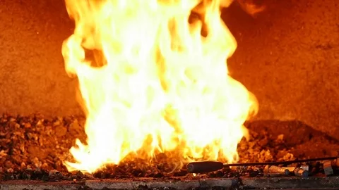 Blacksmith Puts Iron in a Forge Stock Footage 81547753