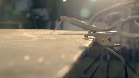 The blacksmith puts on the table forged metal product in the form of heart Stock Footage 76396642