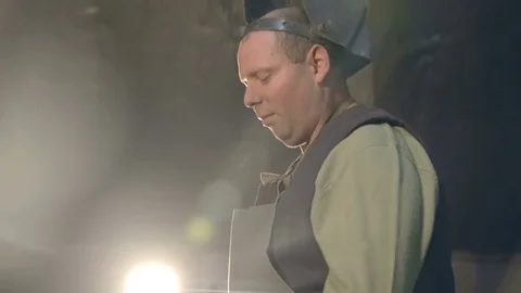 The blacksmith puts on the table forged metal product in the form of heart Stockbeeldmateriaal 76396719