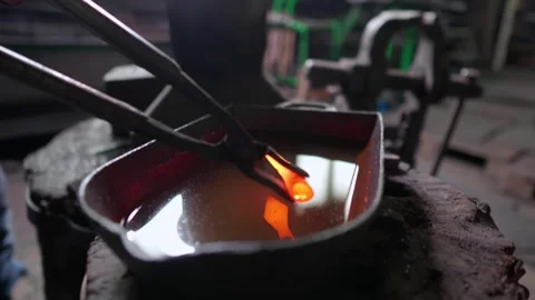 Blacksmith quenching traditional arrowhead Stock Footage 245263155