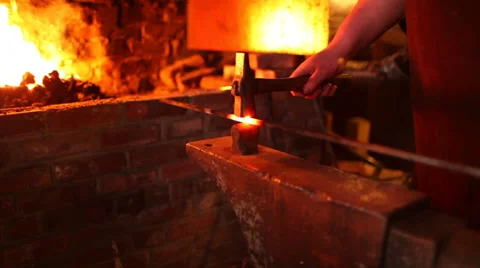 Blacksmith removes iron rod from fire, begins to forge on anvil, medium shot 스톡 동영상 39022467